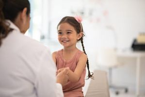 Female doctor talking to a child.