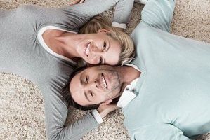 man and woman lying on a carpet